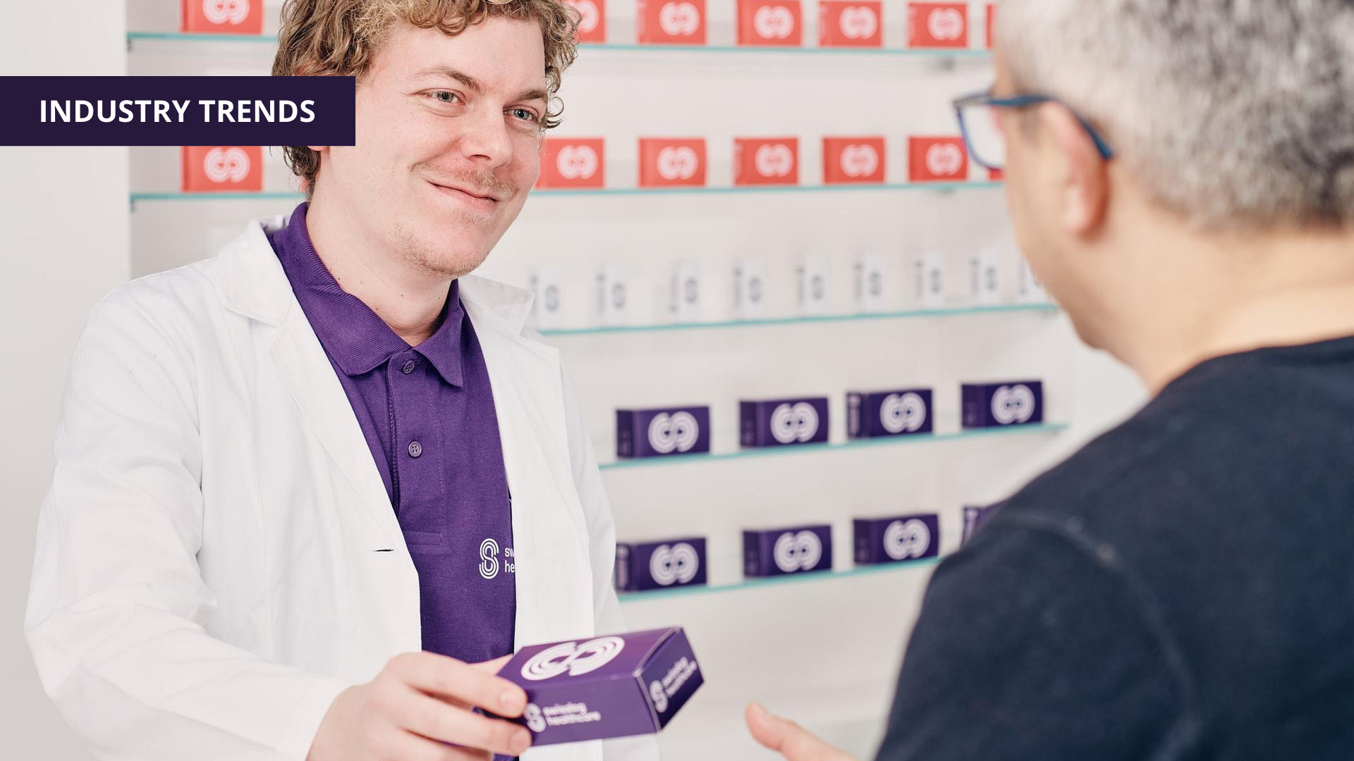 Pharmacist handing medication to patient